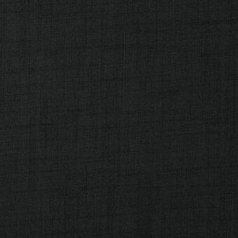 Dark gray textured fabric with a tight woven structure and subtle nubby pattern, exhibiting a matte finish and diagonal twill weave.