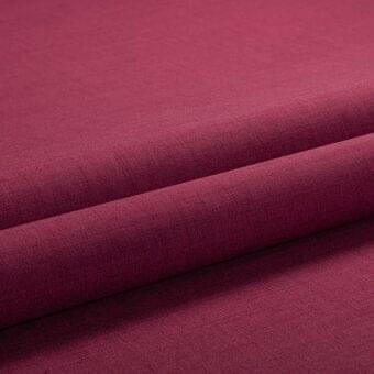Burgundy knit fabric swatch, diagonally folded, displays a smooth matte texture and consistent color, identified as lacividina tailor copertina.