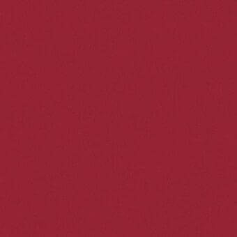 Crimson fabric texture sample displaying a muted, saturated color and subtle granular weave with a matte finish against a lighter red backdrop.