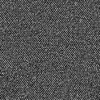 Textured fabric pattern in white and dark gray, composed of irregular small elements, creating a granular woven textile with no dominant motif.
