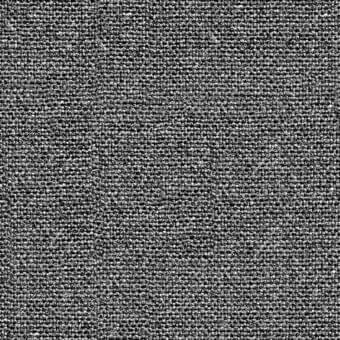 Flax fabric in grayscale tones displays a dense, granular texture with an intricate, tight weave and consistent speckled pattern.