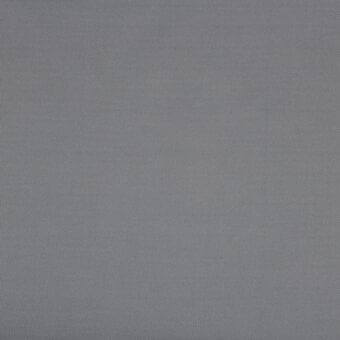 Gray woven fabric texture with a uniform dot pattern, matte finish, and consistent medium gray tone, studio shot for material properties.
