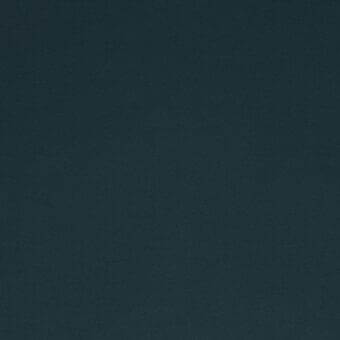 Dark teal stretchy fabric sample with a repeating dot geometric pattern, woven texture, and matte finish from Lacividina fabrics.