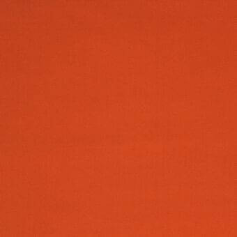 Orange stretchy fabric swatch with a matte finish and repeating dot pattern, displaying a woven texture and consistent warm color.