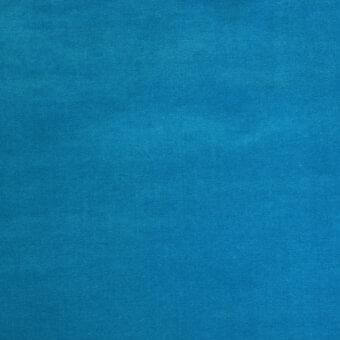 Teal woven fabric sample displaying a granular texture, with tonal variations and a matte finish throughout the tight grid pattern.