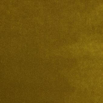Textured gold fabric sample with a dense woven grain and matte finish, displaying subtle color variations and a softly distressed appearance.
