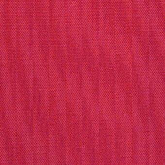 Red lacividina fabric with a dense, granular weave and subtle blue-purple threads, exhibiting a matte finish and textured surface.