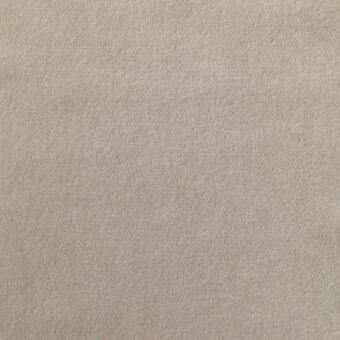 Warm gray fabric sample displaying a dense, granular texture; label reads “lacividina 29 ariana 7061.09” denoting brand and fabric details.