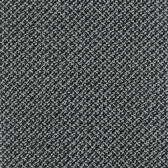 Woven fabric sample in grayscale tones displays a dense, irregular texture with a speckled pattern; label reads “lacividina 34 cleo carbon”.