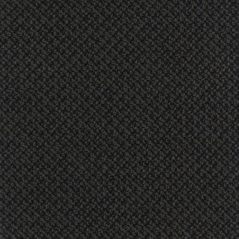 Charcoal gray floral fabric with repeating stylized blooms, exhibiting a looped texture and granular pattern, detailed tonal variations.