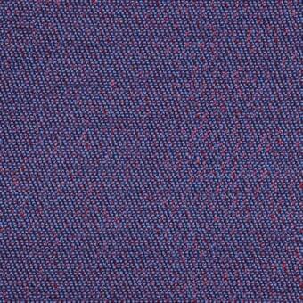 Blue woven fabric with red flecks, dense tight weave, granular texture, matte finish, studio shot close-up, durable material.