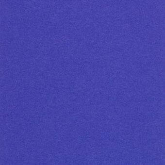 Indigo woven fabric texture with a matte finish and granular composition, suitable for upholstery or drapery projects.