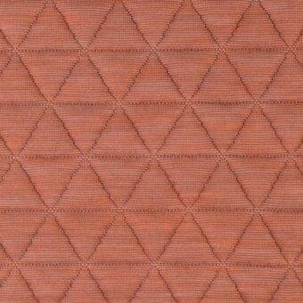 Blush quilted textile with repeating diamond pattern, featuring fine raised stitching and a subtle heathered texture, light gray contrast.