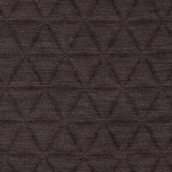 Dark brown quilted fabric displaying a repeating triangular pattern in a diamond grid, with a tightly woven, textured surface.