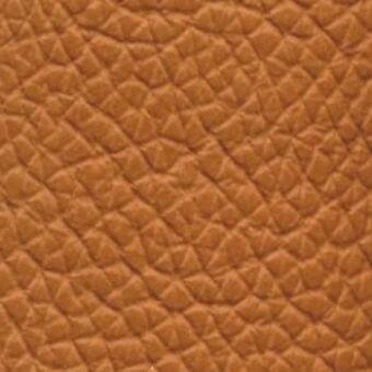 Tan leather texture with repeating geometric pattern, exhibiting a pebbled surface and matte finish, ideal for upholstery applications.