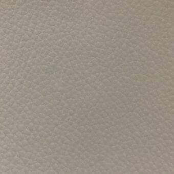 MDF Italia fabric sample, ivory textured weave, densely pebbled surface with matte finish and neutral col. 6747 tone on gray background.