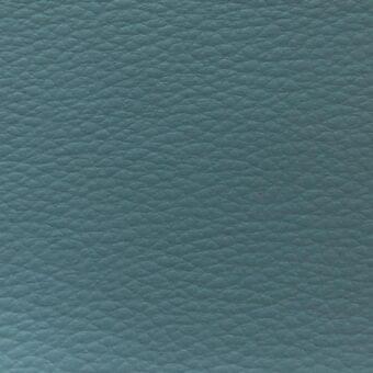 Powder blue fabric texture, “time tl15” from MDF Italia, displays a dense, pebbled surface with subtle tonal variations and a matte finish.