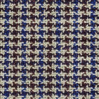 Beige, blue, and brown woven fabric sample with a nubby texture and irregular star-shaped motifs; textile identification text visible.