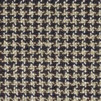 Beige brown floral fabric sample with repeating four-petaled motifs, dark gray-blue background, textured matte weave, MDF Italia collection.