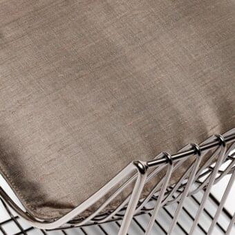 Chair seat cushion upholstered in delhi marrone r397 140 fabric with a textured weave and a chrome metal crisscross frame.