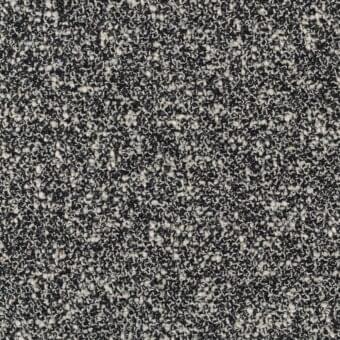 MDF Italia fabric sample, dark gray and off-white, granulated texture with mottled color distribution and matte finish.