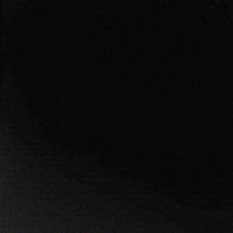 Graphite grey matte surface, uniform texture, consistent color x054, flat monochromatic plane, MDF Italia, granular painted finish.