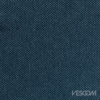 Teal woven fabric texture with silver flecks, displaying a granular surface and visible yarn structure; “VESCOM” logo imprinted.