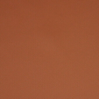 Fabric swatch in matte brick red with a fine, granular texture resembling pebbled leather, displaying tonal variations and a densely woven appearance.