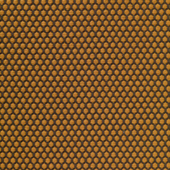 Geometric textile sample in mustard yellow and charcoal gray features a woven, repeating hexagon grid pattern; Vescom rolla collection.