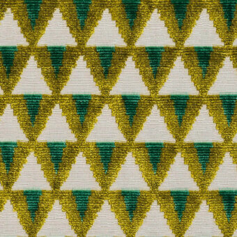 Beaded geometric fabric pattern with emerald green, golden-yellow, and white triangles in a tessellated grid; Dedar Amuleto Smeraldo textile.