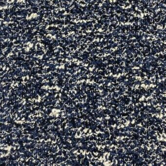 Navy blue and off-white boucle fabric texture with looped pile, displaying irregular nubby weave and visible “moroso” fabric label.
