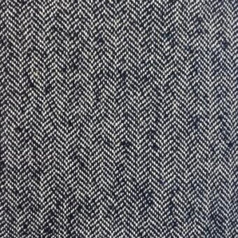 Herringbone fabric texture in charcoal gray and off-white, dense weave with chevron pattern; Moroso “House of Lords A6944–999 Black”.