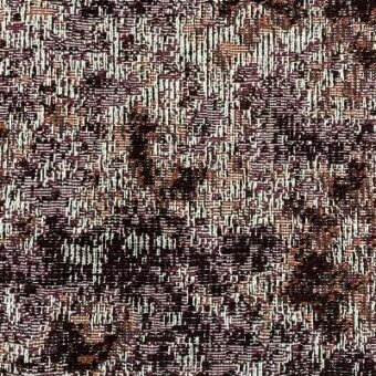 Woven fabric sample, brown and orange tones, irregular mottled texture with visible vertical and horizontal weave structure and label detail.