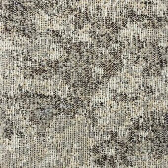 Moroso Nembro fabric, color 20 Sand, displays a dense, irregular weave of beige, gray, and black textural elements on an off-white warp background.