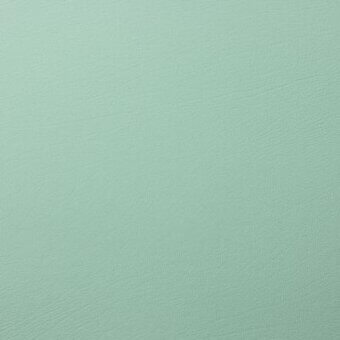 Moroso Boltaflex fabric sample, pale mint green, smooth matte texture with subtle grain and printed product details.