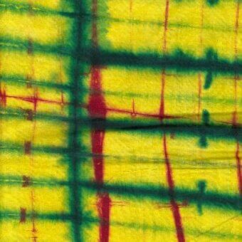 Batik-style textile sample with dark green and red grid lines on yellow, woven texture, rectangular shapes, Moroso Afrobatik fabric A6185.