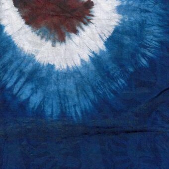 Tie-dye textile sample with blue, white, and burgundy circular pattern; feather-like shapes on textured fabric, Moroso Afrobatik Blue print.