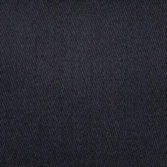Dark blue-black fabric texture with a tight diagonal rib weave, matte finish, and visible “moroso senales” label detail.