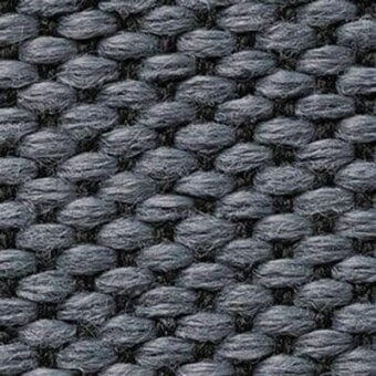 Basalt gray woven fabric displaying a repeating geometric loop pile pattern with a heathered, nubby texture and subtle tonal variations.
