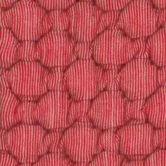 Red quilted fabric with honeycomb cell pattern, white stripes, visible stitching, and “moroso big pois” textile identification.