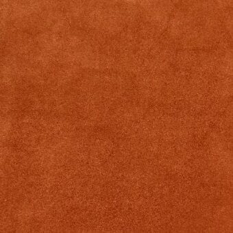 Suede-like fabric texture in sunstone orange with tonal variations, dense short pile, matte finish, and subtle identifying text.