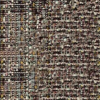 Woven fabric sample, muted brown with mustard, olive, pink, and cream threads, exhibiting a dense, irregular geometric pattern and nubby texture.