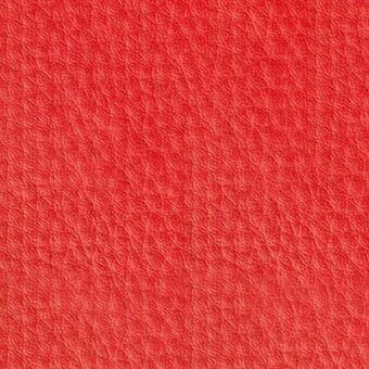 Ruby-red leather texture with a consistent pebbled grain, matte finish, and uniform color, suggesting durable upholstery material.