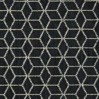 Rabat fabric sample, charcoal gray and beige geometric pattern, interlocking hexagons and diamonds with a tight weave texture.