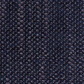 Dark blue woven fabric texture with a dense, raised pattern of muted plum elements and a subtle grid weave, matte finish.