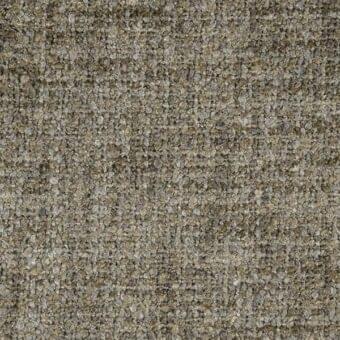 Textured olive green fabric sample displaying a granular, mottled patchwork with embedded particles and a slightly rough, uneven surface.