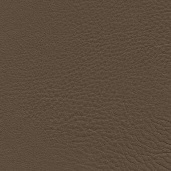 Porada leather upholstery texture, medium-brown full-grain leather, dense irregular grain pattern with matte finish and label detail.
