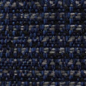 Woven tweed-like fabric texture with deep blue, gray, and black horizontal bands, featuring a dense, nubby, irregular knot pattern.