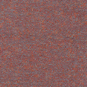 Terracotta outdoor fabric with a dense, irregular weave and heathered texture, featuring gray and orange threads.