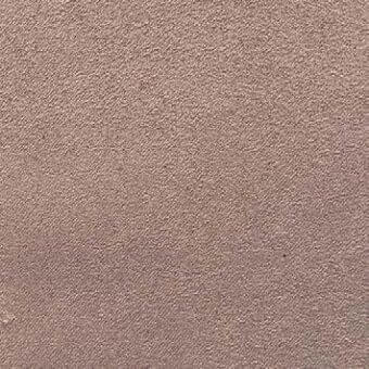 Dusty rose fabric texture with a granular, matte finish and subtle velvety quality, shown in a studio close-up.